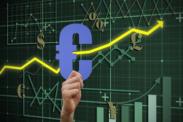 Composite image of hand holding euro sign