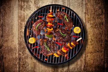 Foto op Canvas Top view of fresh meat and vegetable on grill placed on wooden floor © Jag_cz