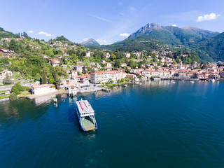 Fototapeta na wymiar Menaggio - Ferry boat in a port - Como lake in Italy