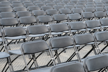 many empty black folding chair rows