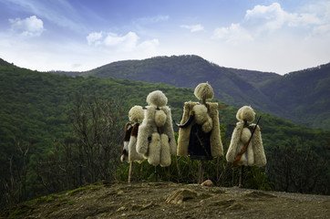Naklejka premium Traditional clothes of Caucasian peoples, sheepskin coat and fur hats from sheep's wool in nature background