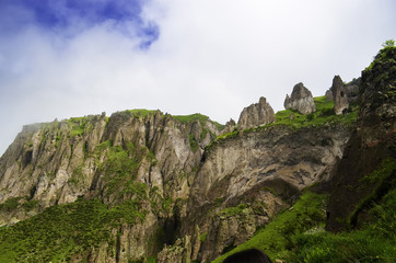 Beautiful mountain landscape, with mountain peaks covered with forest and a cloudy sky. Armenian and Georgian mountains, Caucasian mountain range