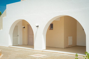 Greek architecture - white buildings, sea and blue windows, tree and flower