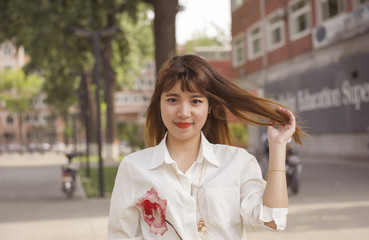 Young woman smiling and looking at camera in campus.