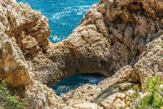 Natural archs created by the sea near creek of Moraig,  Benitatxell, Spain