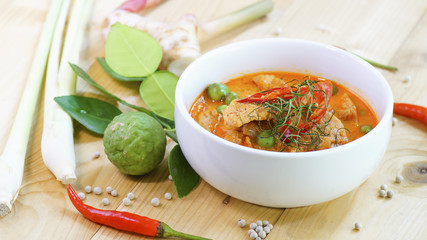 Panaeng Curry with Pork with spices, chili, lemon grass,bergamot leaf on wood