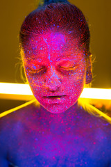 portrait of beautiful young woman with pink studio light