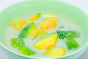 Close-up view. Desserts musk melon a little piece with coconut milk in a bowl.