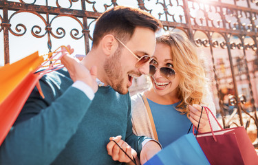 Shopping time. Beautiful couple in shopping. Consumerism, shopping, lifestyle concept