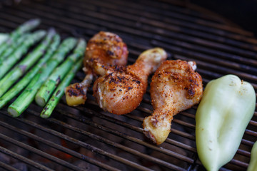 Barbecue chicken leg drumstick with asparagus on grill