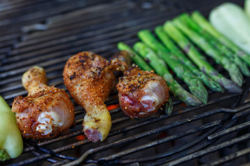 Barbecue chicken leg drumstick with asparagus on grill