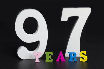 Letters and numbers ninety-seven years on a black background.