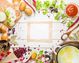 Preparation of soup at home. Rustic white background with vegetables and ingredients around the perimeter.