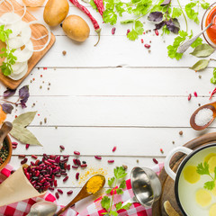 Preparation of soup at home. Rustic white background with vegetables and ingredients around the perimeter.