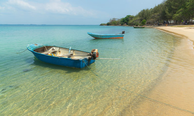 Naklejka na ściany i meble Seaside beach view with fisher boat see through the water to sebase