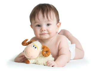 baby boy lying on tummy with lamb toy isolated