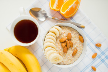 oatmeal , tea, orange, bananas. Top view
