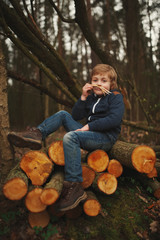 little sweet lumberjack in autumn forest