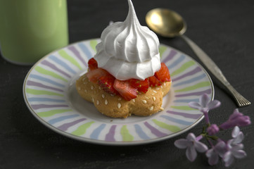 berry tartlet with meringue and strawberries. on a wooden Board