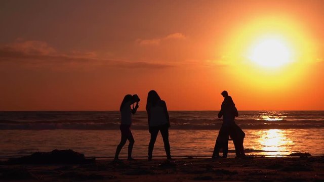 High quality video of happy family on the beach at the sunset