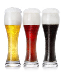 Three glasses of different fresh foamy beer