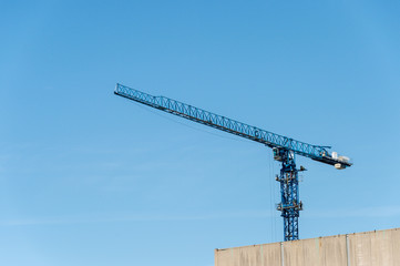 Construction crane against blue sky