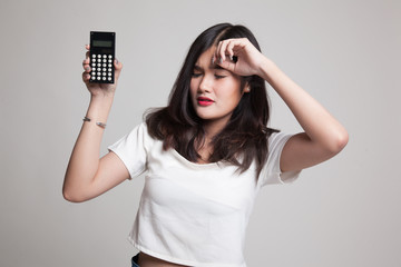Asian woman got  headache with calculator.
