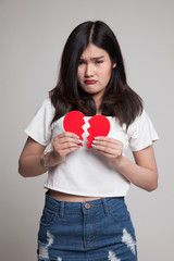 Fototapeta premium Beautiful young Asian woman with broken heart.