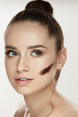 Fototapeta premium Beauty Cosmetics. Young Woman With Stripe Of Coffee Mask On Skin