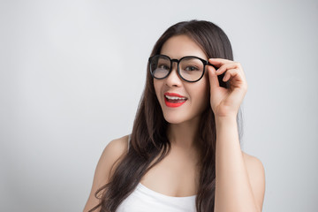 Young beautiful Asian woman with smiley face wearing glasses.