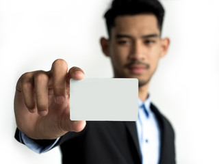 Businessman reach out on camera and show credit card or visit card, close up