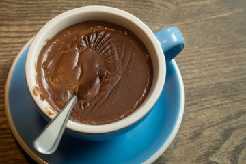 Blue Cups of hot Chocolate drink on dark wooden background. Morning time. Holiday concept