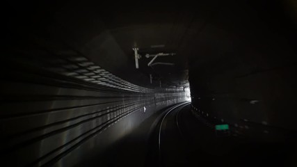 Out of the Tunnel. New Hope.
Subway tunnel view as seen from a forward moving train. Train goes out of the tunnel. 
