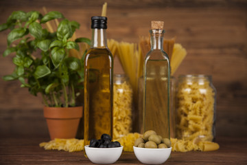 Dry pasta with ingredients on a old wood