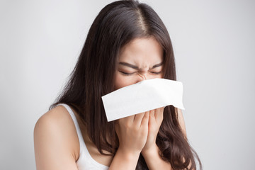 Young Asian woman sneezing, catch a cold.