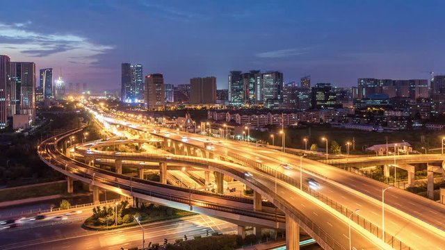 Time lapse of the busy interchange traffic in city from day to night