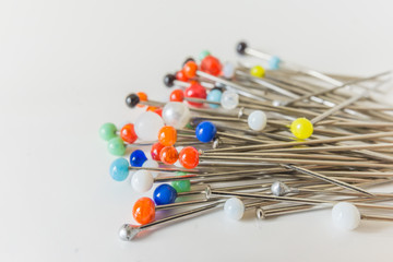 Close-up of sewing pins on  white backgrounds, soft defocus in depth, hobby concept.