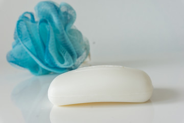 Fototapeta na wymiar Close-up of a sponge for a bath and soap, on a white background. Health care concept.
