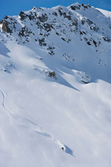 Fototapeta na wymiar Skier carving through powder snow