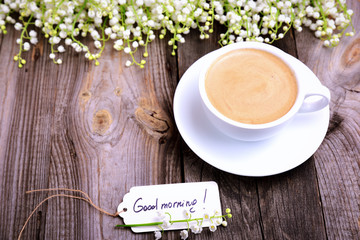 Cup of coffee and a paper tag with the inscription good morning