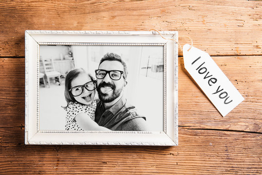 Fathers day concept. Picture frame. Wooden background.