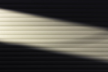 A diagonal beam of light on the wall.