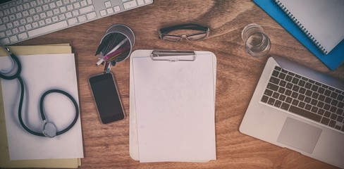 Various equipment and technologies on doctors desk in hospital