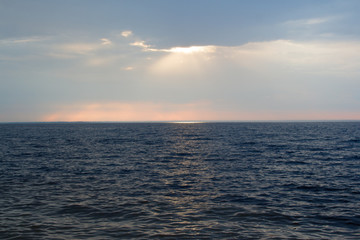 Sea sunset, in warm tones on a rocky shore