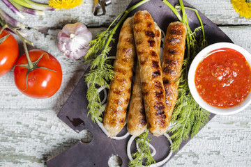 Grilled sausage with sauce and vegetables