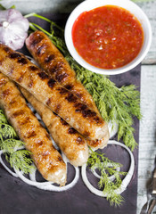 Grilled sausage with sauce and vegetables