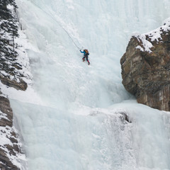 Ice climber on frozen waterfall, Lake Louise, Banff National Park, Alberta, Canada
