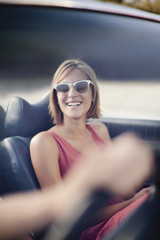 Woman riding in convertible