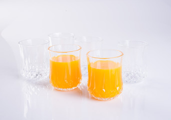 Orange juice in glasses on white background.