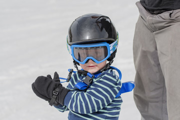 Toddler Ready to Ski Safely with Helmet and Harness